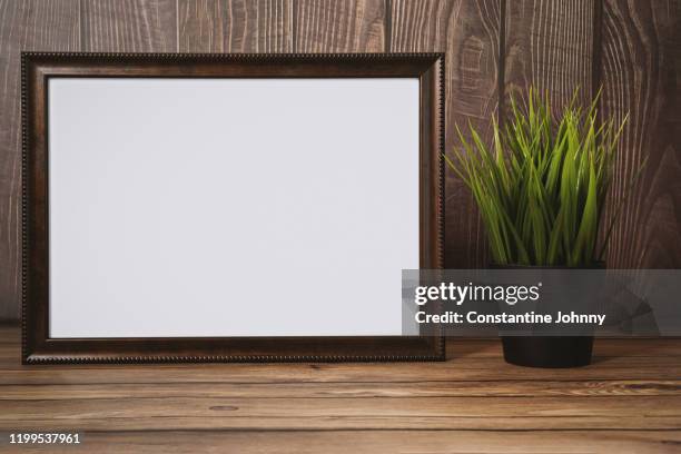 blank wood frame and potted plant against rustic wood - certificate border stock pictures, royalty-free photos & images