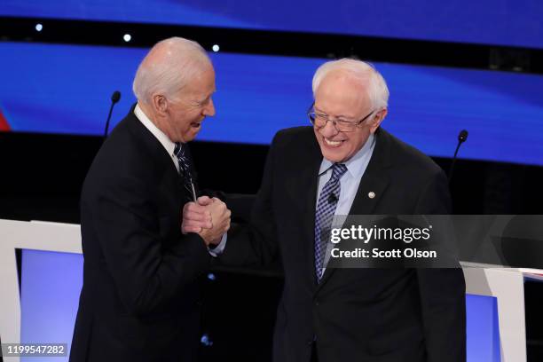 Former Vice President Joe Biden greets Sen. Bernie Sanders before the Democratic presidential primary debate at Drake University on January 14, 2020...