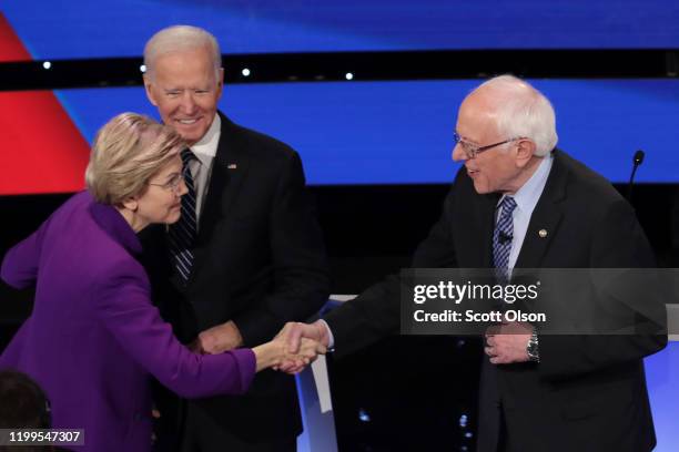 Sen. Elizabeth Warren greets Sen. Bernie Sanders as former Vice President Joe Biden looks on ahead of the Democratic presidential primary debate at...