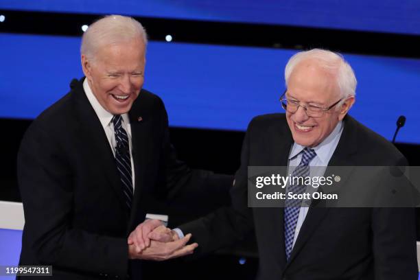 Former Vice President Joe Biden greets Sen. Bernie Sanders before the Democratic presidential primary debate at Drake University on January 14, 2020...