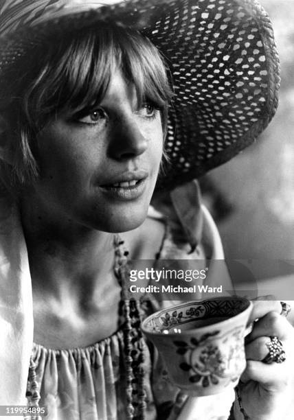 Singer Marianne Faithfull having a cup of tea at home, 1967.