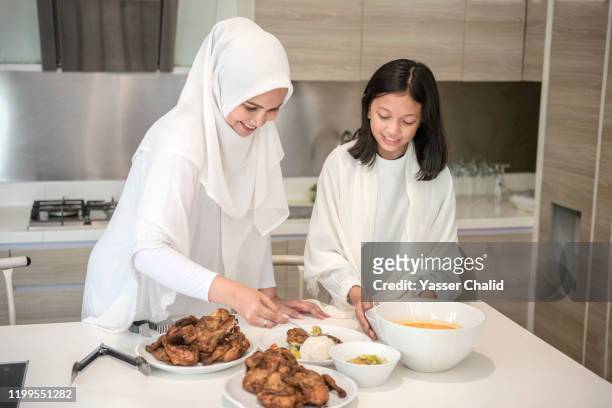 mother and daughter preparing meal - muslims prepare for eid in indonesia stock pictures, royalty-free photos & images
