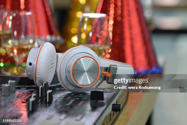 dj player decks with headset against with light glitter bokeh - christmas photo album stock pictures, royalty-free photos & images