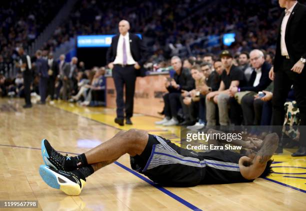 Jacob Evans III of the Golden State Warriors lies on the court after being injured during their game against the Dallas Mavericks at Chase Center on...