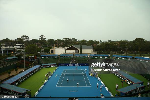 CoCo Vandeweghe of the USA hits some balls with the ball kids as rain suspends play during the Women’s Singles match between CoCo Vandeweghe of the...