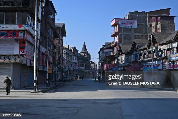 Kashmiri pedestrian walks along a street in central Lal Chowk area during a one-day strike called by Jammu and Kashmir Libration Front to demand the...