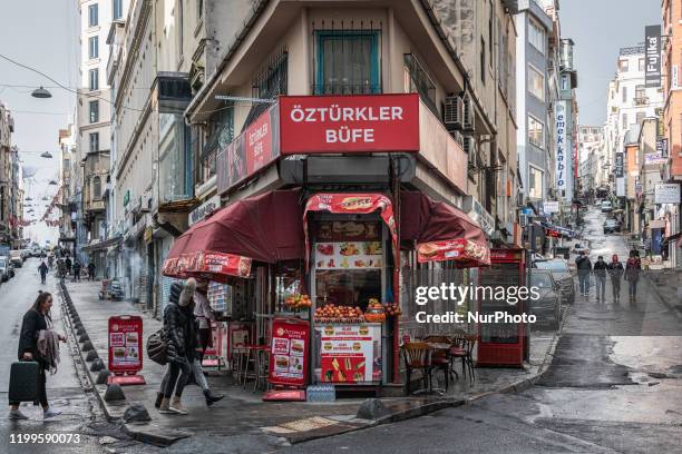 On Feb. 8 pedestrians pass by a corner store and doner kebab restaurant in the Beyoglu district of Istanbul, Turkey.