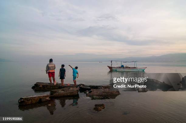Mother and her children fish at the seashore of Kampung Lere, Palu, Central Sulawesi, Indonesia on February 9, 2020. The life situation around the...
