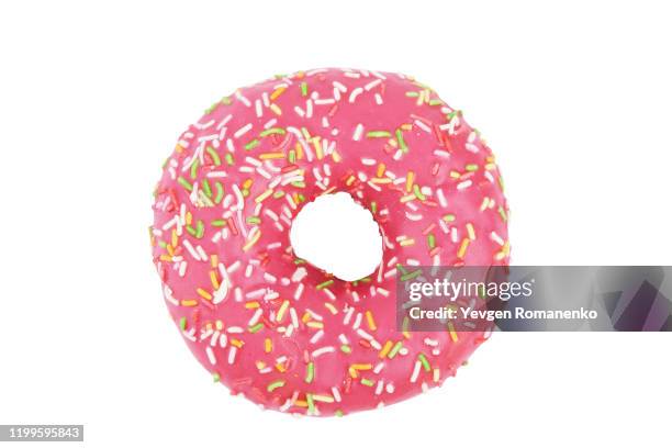 pink donut with colourful sprinkles isolated on white background. top view. - fried dough stock pictures, royalty-free photos & images