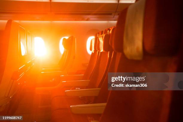 passenger boading in airplane from window seat on board of airplane - jet ski stock-fotos und bilder