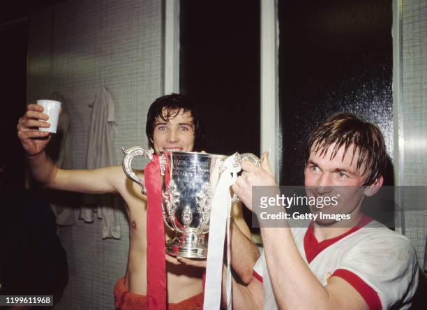 Liverpool goal scorer's Alan Hansen and Kenny Dalglish celebrate with the trophy in the dressing room after the 1981 League Cup Final replay victory...