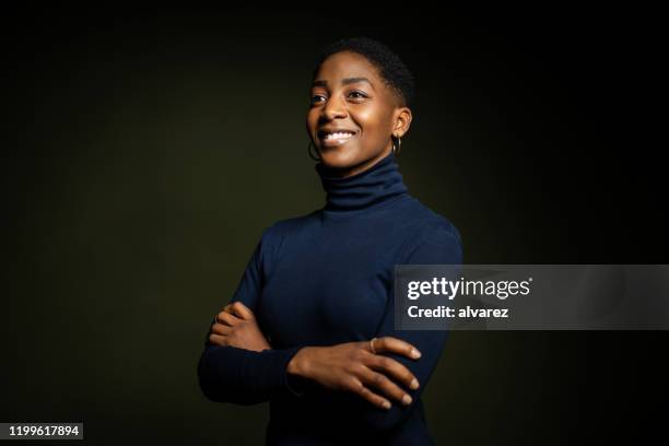 confident african american woman on dark background - waist up stock pictures, royalty-free photos & images