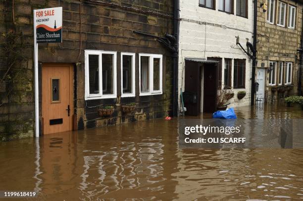 Flood water laps at the door of a house, advertised for sale, in Mytholmroyd, northern England, on February 9 after the River Calder burst its banks...