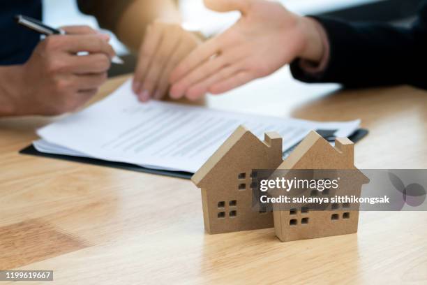 customer signing a real estate contract in real estate agency. - real estate law stock pictures, royalty-free photos & images