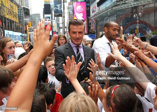Soccer stars David Beckham and Thierry Henry sign autographs for fans on "Good Morning America," 7/25/11, on the Walt Disney Television via Getty...