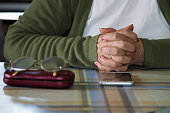 older woman's hands with mobile phone