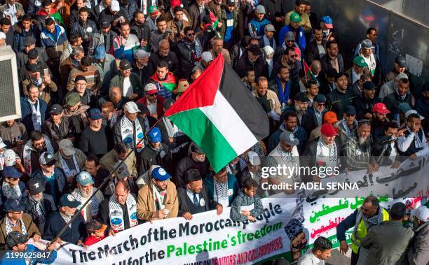 Moroccans wave the Palestinian flag during a demonstration against the US Middle East peace plan in the capital Rabat on February 9, 2020. - Morocco...