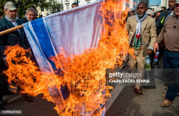 Moroccans burn the Israeli flag during a demonstration against the US Middle East peace plan in the capital Rabat on February 9, 2020. - Morocco has...