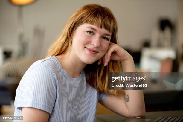 portrait of strawberry blonde young woman with nose piercing in a coffee shop - rosy cheeks stock pictures, royalty-free photos & images