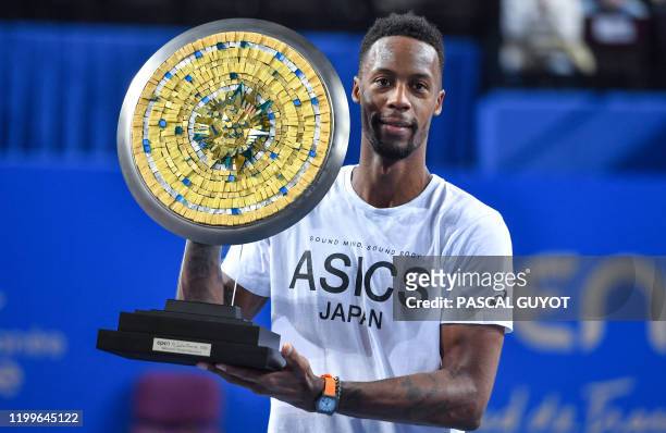 France's Gael Monfils poses with his trophy at the end of the final of the Open Sud de France ATP World Tour in Montpellier, southern France, on...