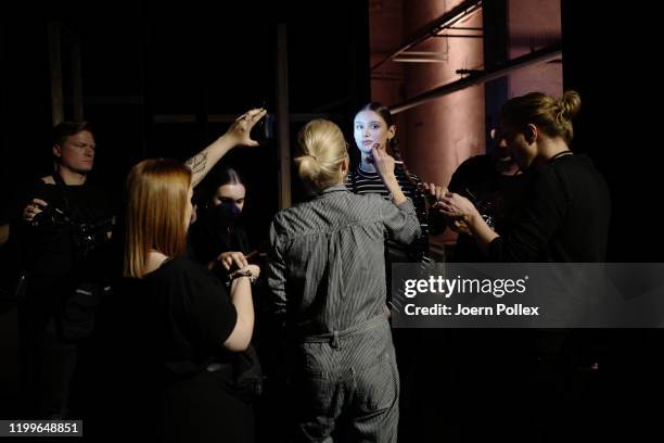 Model is prepared backstage ahead of the Lena Hoschek show during Berlin Fashion Week Autumn/Winter 2020 at Kraftwerk Mitte on January 15, 2020 in...