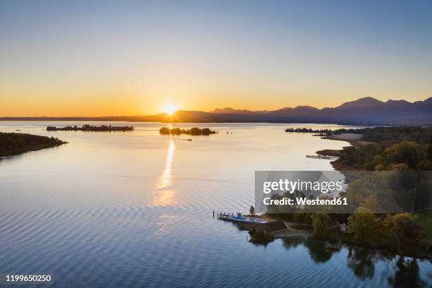 germany, bavaria, aerial view of chiemsee lake at sunrise - schloss herrenchiemsee stock-fotos und bilder