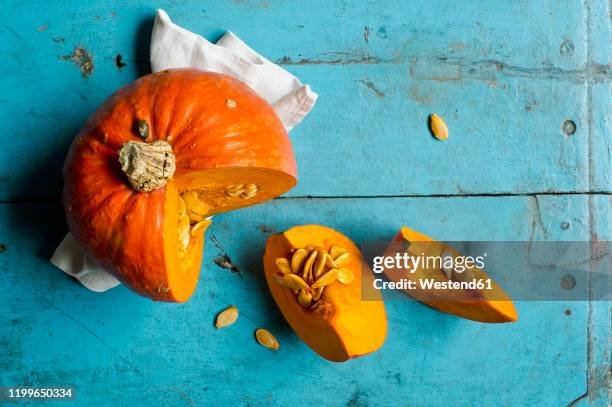 red kuri squash (cucurbita maxima) on blue cutting board - squash vegetable stock pictures, royalty-free photos & images