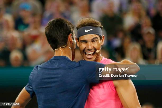 Novak Djokovic of Serbia and Rafael Nadal of Spain hug during the Rally for Relief Bushfire Appeal event at Rod Laver Arena on January 15, 2020 in...