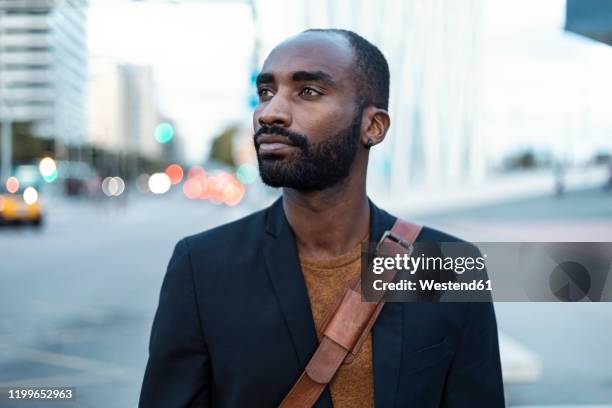 portrait of young businessman in the city - looking around stock pictures, royalty-free photos & images