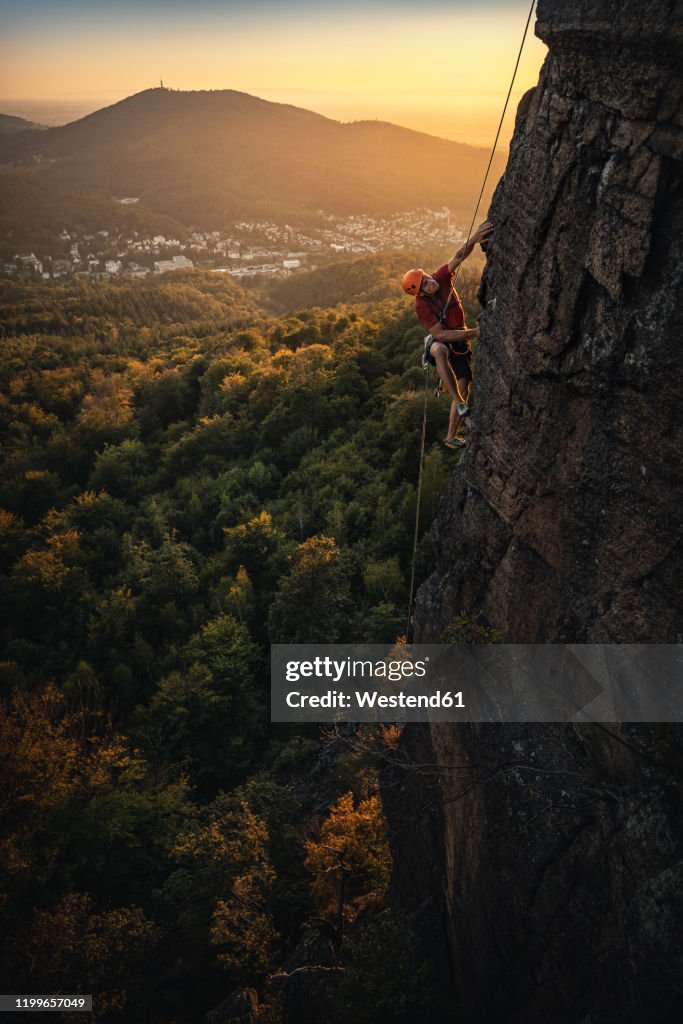 Man climbing at Battert rock at sunset, Baden-Baden, Germany