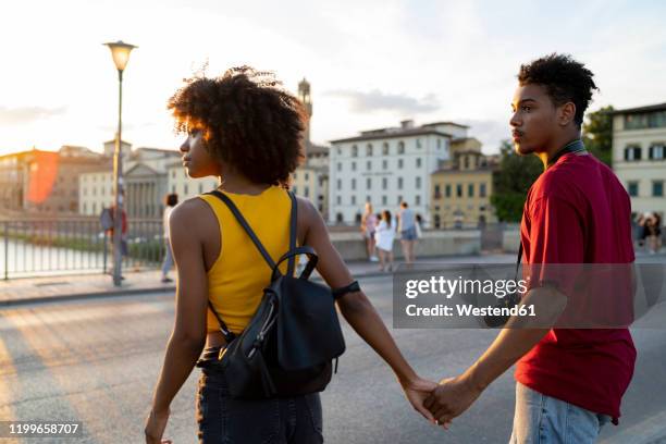 young tourist couple exploring the city at sunset, florence, italy - florence italy city stock pictures, royalty-free photos & images