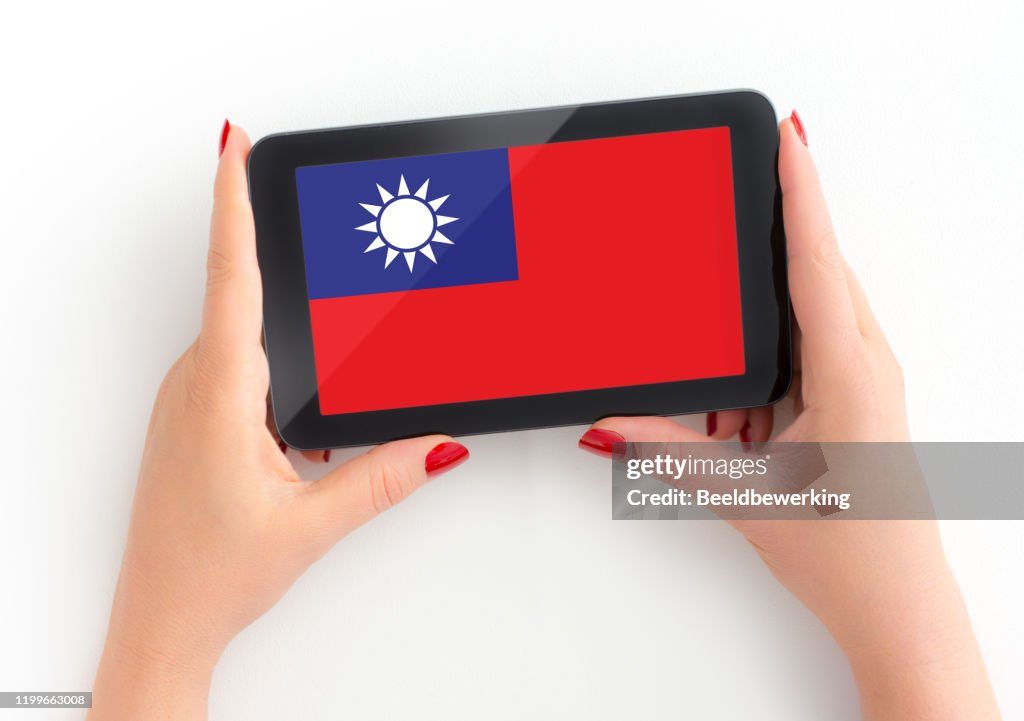 Taiwanese Flag on digital tablet in mature female hand with Personal Perspective