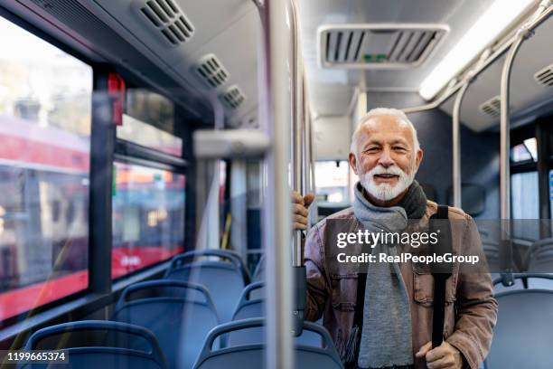 senior man in de bus - travel real people stockfoto's en -beelden