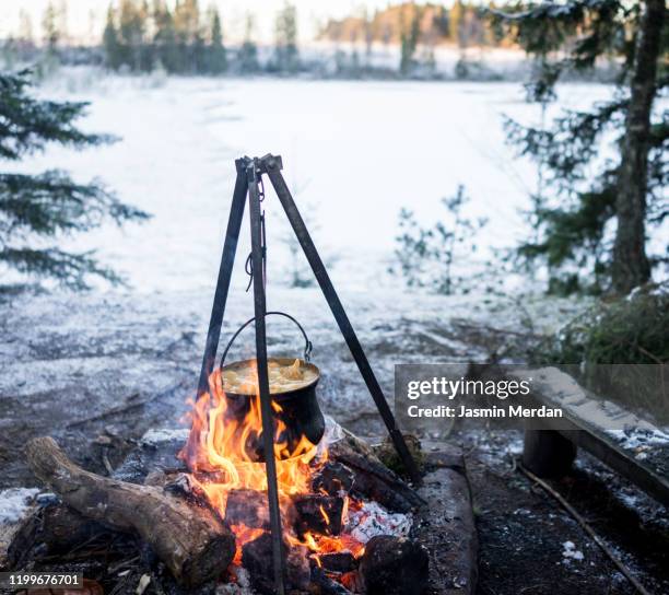 preparing food in cooking pot on campfire - campfire no people stock pictures, royalty-free photos & images
