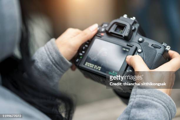 checking photo in camera screen - digital camera stock pictures, royalty-free photos & images