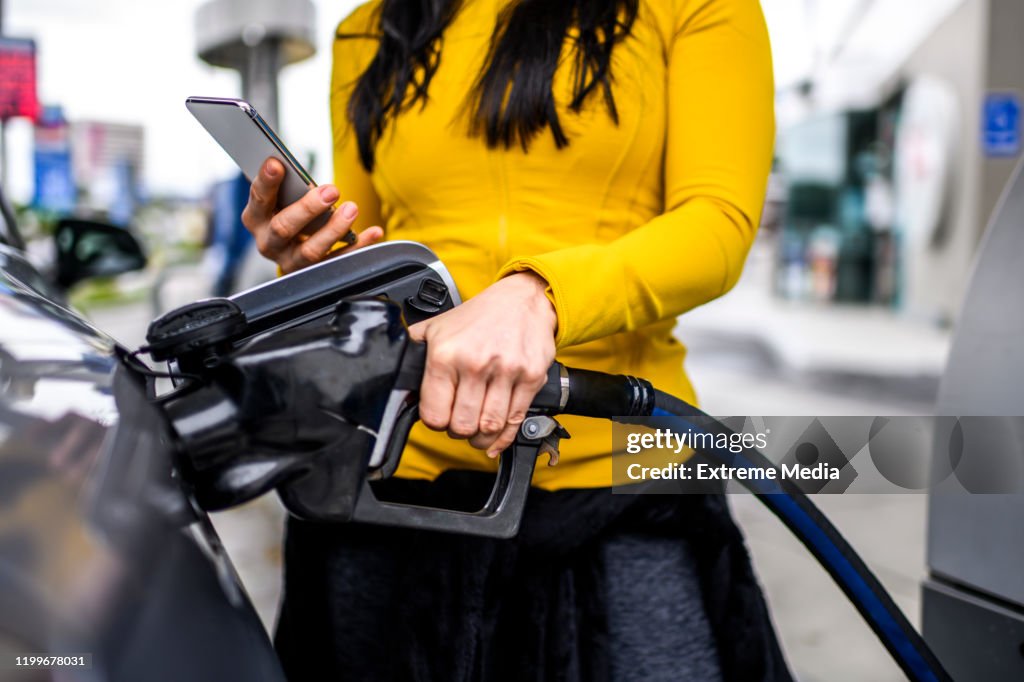 Filling a car with gas at a station
