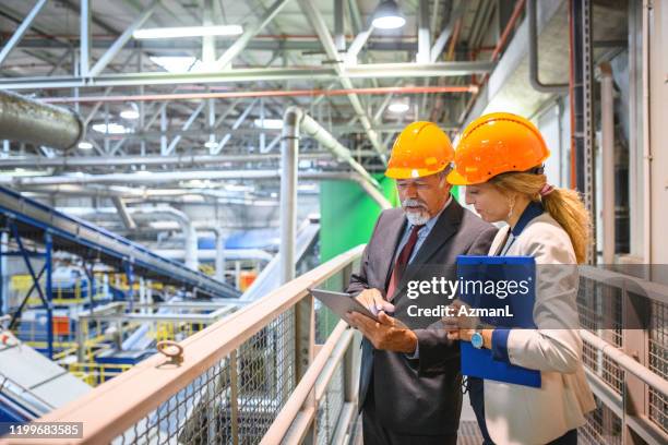 manager and quality controller inside recycling facility - waste management stock pictures, royalty-free photos & images