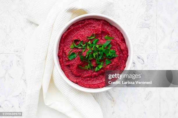 bowl of beetroot hummus with parsley topping - beet ストックフォトと画像