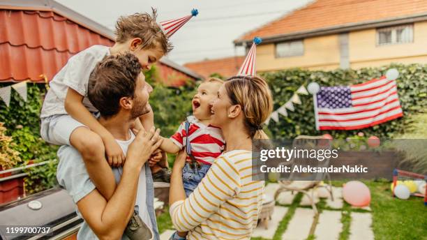 happy family celebrating fourth of july - fourth of july stock pictures, royalty-free photos & images