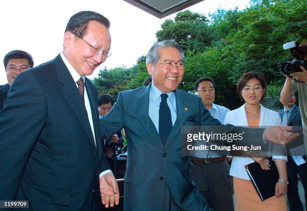 Chinese Foreign Minister Tang Jiaxuan is greeted by his South Korean counterpart Choi Sung-hong before a meeting at Choi's residence August 2, 2002...
