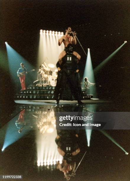 Lead singer of Queen, Freddie Mercury , sits on the shoulders of Star Wars character Darth Vader, as bassist John Deacon and lead guitarist Brian May...