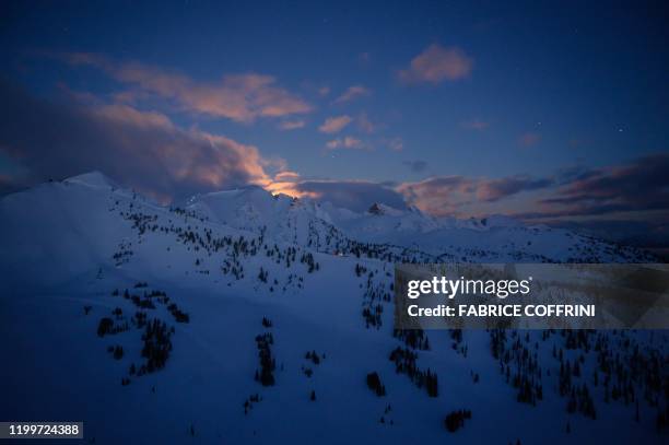 This image taken on February 7, 2020 shows shows the Ozone mountain at sunrise prior to the second stage of the Freeride World Tour skiing and...