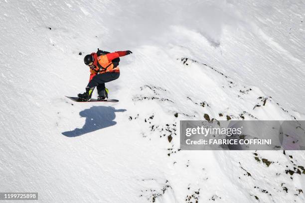 This image taken on February 7, 2020 shows freeride snowborder Jonathan Penfield of the US competing during the Men's snowboard event of the second...