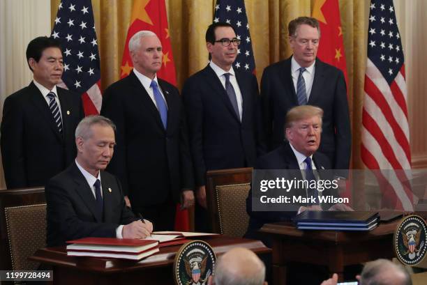 President Donald Trump and Chinese Vice Premier Liu He sign phase 1 of a trade deal between the U.S. And China, in the East Room at the White House,...