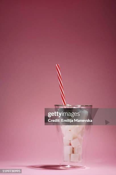 drinking glass full of sugar cubes - sugar cubes in tea stock pictures, royalty-free photos & images
