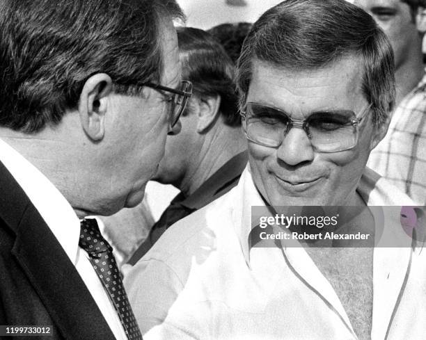 Bill France Jr. , the CEO of NASCAR, talks with racecar owner and movie director Hal Needham in the speedway garage area prior to the start of the...