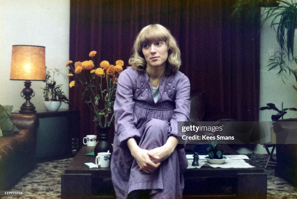 Young woman sitting on coffee table