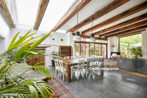 spacious dining area in a bright refurbish mediterranean farmhouse - roof beam stock pictures, royalty-free photos & images