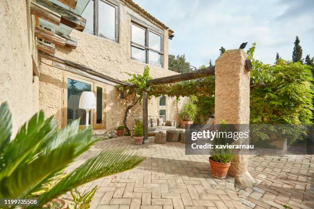 chill area in a mediterranean farmhouse backyard garden terrace - rustic wall stock pictures, royalty-free photos & images