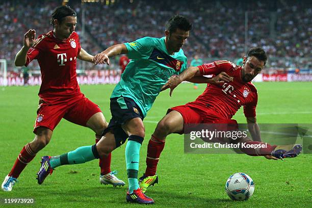 Danijel Pranjic of Bayern and Diego Contento of Bayern challenge David Villa of Barcelona during the Audi Cup final match between FC Bayern Muenchen...